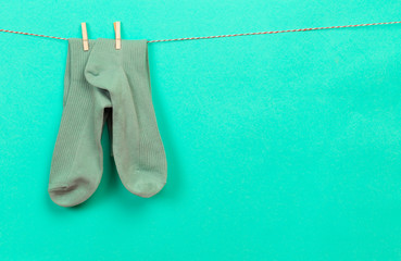 colorful   socks hanging on a rope on pastel   background - Image