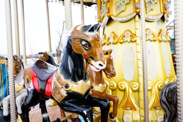 children's carousel with horses, holiday attraction