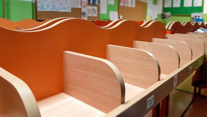 Little wooden shelves in a kindergarten changing room. 