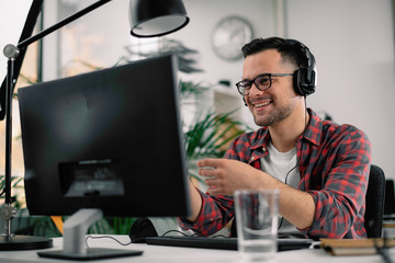 Businessman on video call. Handsome man in office with headphones. 