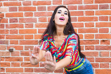 Obraz na płótnie Canvas Street shaabi dance and urban dancer concept - Cheerful belly dancer dancing with arabic music on the street