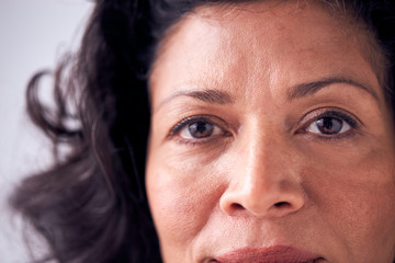 Close Up On Eyes Of Smiling Mature Woman In Studio