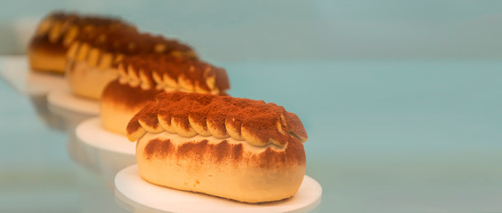 Close up delicious healthy chocolate cakes sprinkled with cocoa without lactose, gluten free, only natural products in a cafe window. Copy space for your text