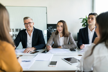 Startup business team on meeting in modern office interior and working on laptop