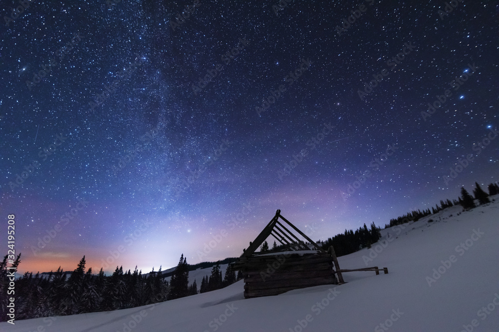 Wall mural a bright starry night in the mountains with the milky way in the sky, venus and millions of stars hi