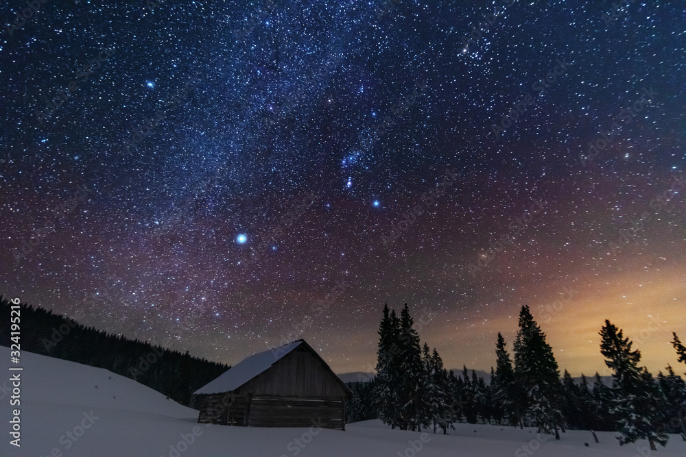 Wall mural a bright starry night in the mountains with the milky way in the sky, venus and millions of stars hi