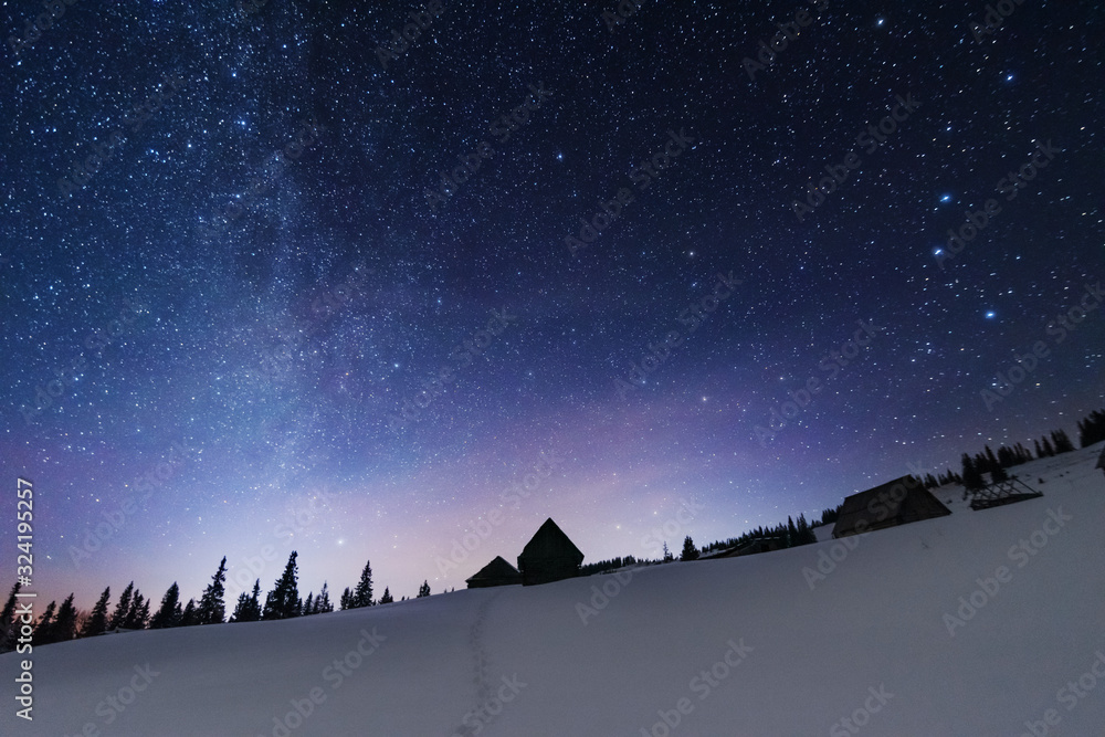 Wall mural a bright starry night in the mountains with the milky way in the sky, venus and millions of stars hi