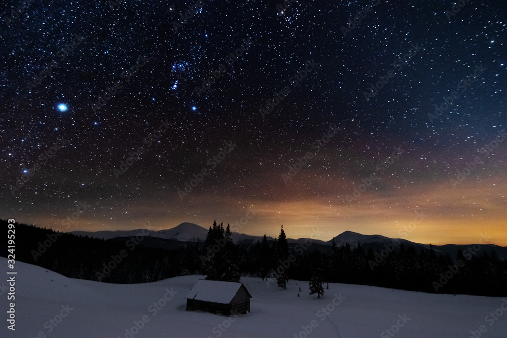 Wall mural a bright starry night in the mountains with the milky way in the sky, venus and millions of stars hi
