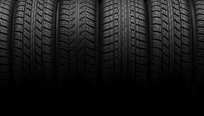 A set of car wheels or tires lie in a row in the shadow on a black background. Mock up for advertising car service or auto maintenance. Copy space. 3D rendering. © Garan Julia