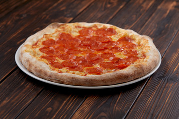 tasty pizza on the wooden background