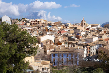Fototapeta na wymiar Panorama of the old town of Relleu on the Mediterranean coast in the province of Alicante, Spain, tiled roofs of the church dome and beautiful pealms