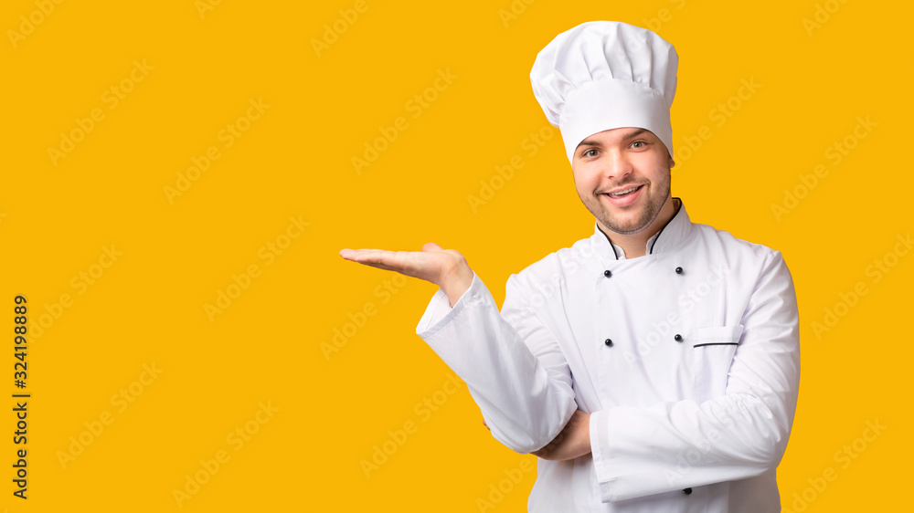 Poster chef man holding invisible object on open palm, yellow background