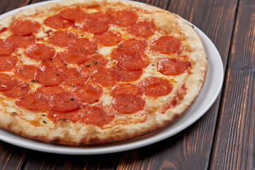 tasty pizza on the wooden background