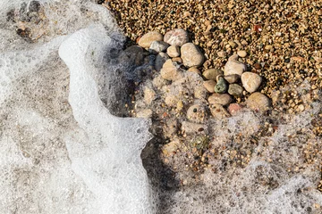 Fotobehang Zen Stenen Heart shape created with sea pebbles on a sand and waves.  © devmarya
