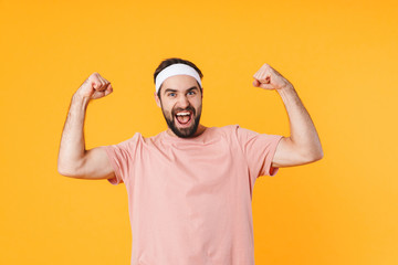 Image of athletic young man in t-shirt showing his biceps