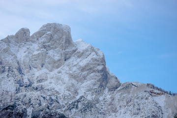 Detail of mountain face with rocks, snow and trees, in The Gesause National Park, Styria region, Austria
