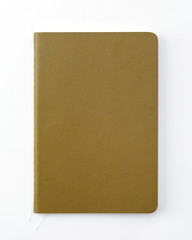 Top view of closed stitch blank recycled paper cover notebook on white background.