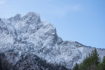 Detail of mountain face with rocks, snow and trees in The Gesause National Park, Styria region, Austria