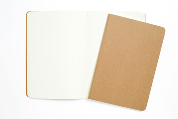 Top view of open stitch blank recycled paper cover notebook on white background.