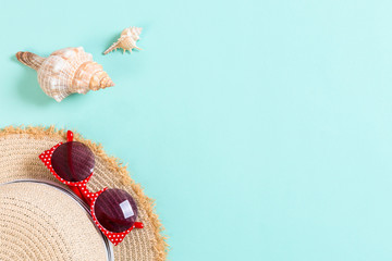 summer holiday beach background with accessories on blue table, top view with copy space. vacation concept