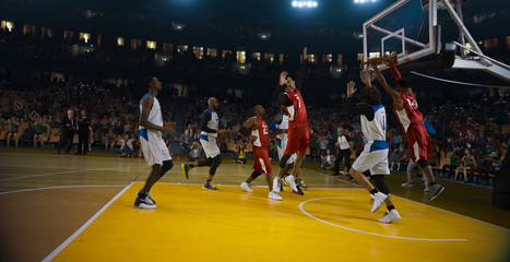 Basketball players on big professional arena during the game. Tense moment of the game. 