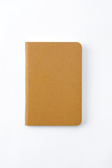 Top view of closed stitch blank recycled paper cover notebook on white background.