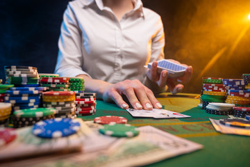 Fototapeta premium Playing poker in a big casino. Online business playing cards, big bets and money. Casino background. Winning and success, risk and fortune.