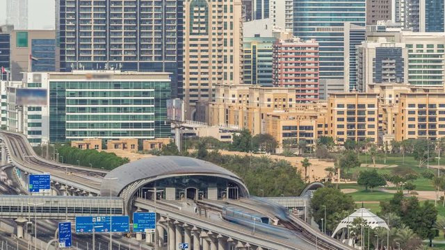 Dubai Golf Course with a cityscape of Gereens and tecom districts at the background aerial timelapse. Traffic on sheikh zayed road with junction and metro starion