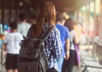 women backpack tourists travel in the market with a lot of people , tourism concep