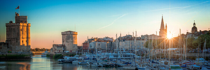 Panorama of the old harbor of La Rochelle, France at sunset - obrazy, fototapety, plakaty