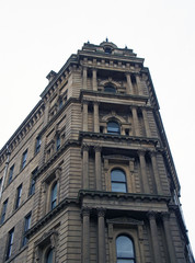 Fototapeta premium perspective view of a 19th century tall stone neoclassical building with ornate columns and windows in the little germany business district of bradford west yorkshire