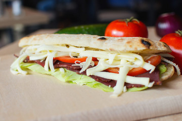 Fresh sandwich on a wooden chopping board