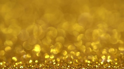 Glitter gold color party luxury beautiful background. Bokeh abstract Christmas season gift shiny