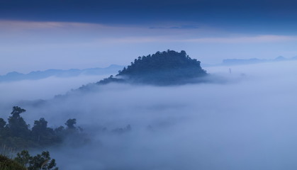 Fototapeta premium view morning of Peak mountain around with sea of mist with cloudy sky background, Khao Sok National Park, Surat Thani, southern Thailand.