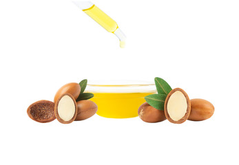 Argan oil isolated. Argan seeds with oil on a white background. Natural bio comestics and oils for skin and hair care from Morocco