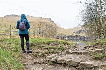 Hiker on route from Janet's Foss to Gordale Scar, Malham, Yorkshire Dales 