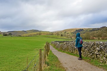 Fototapeta na wymiar Hiker on route to Janet's Foss, from Malham village, Yorkshire Dales.