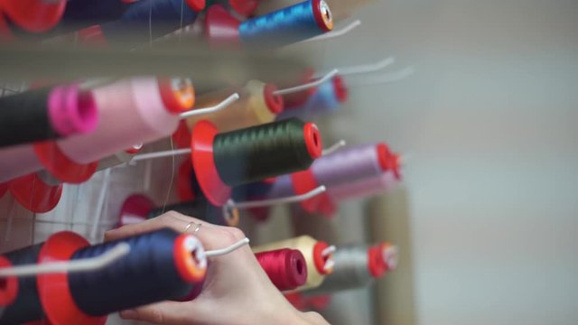 girl chooses thread for sewing