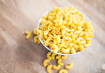Raw macaroni in a bowl.