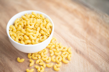 Raw macaroni in a bowl.