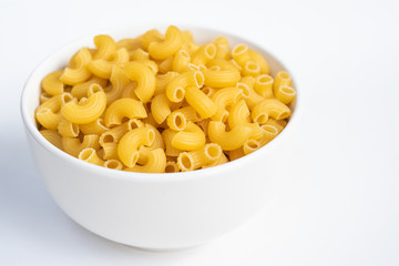 Raw macaroni in a bowl.