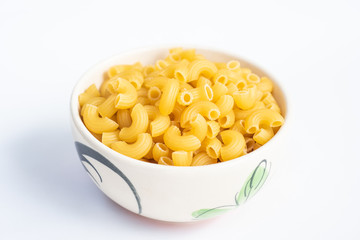 Raw macaroni in a bowl.