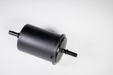 New fuel filter in a black plastic housing for diesel and gasoline engines on a gray background