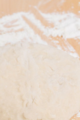 Prepared kneaded dough on a wooden table at home