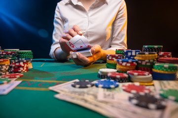 Fototapeta premium Distribution of cards in a night club in a casino. A game with high stakes, a lot of money. Screensaver and advertising for online casinos, poker