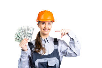 Builder engineer woman holding money in her hands indicates a gesture of her hand on them. An offer to earn dollars at a construction or repair. Isolated