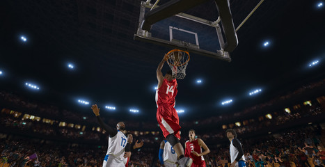 Basketball players on big professional arena during the game. Tense moment of the game. View from below the basket