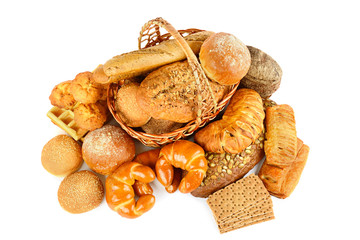 Black and white bread, croissants, buns and biscuits in a basket isolated on white. Top view.