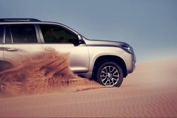 Off-road safari on the golden sands of the desert on a car in Walvis Bay. Namibia. SUV breaks through sand dunes in the desert © Yuliia Lakeienko
