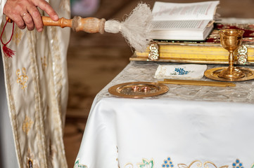 Priest consecrates wedding rings on the plate